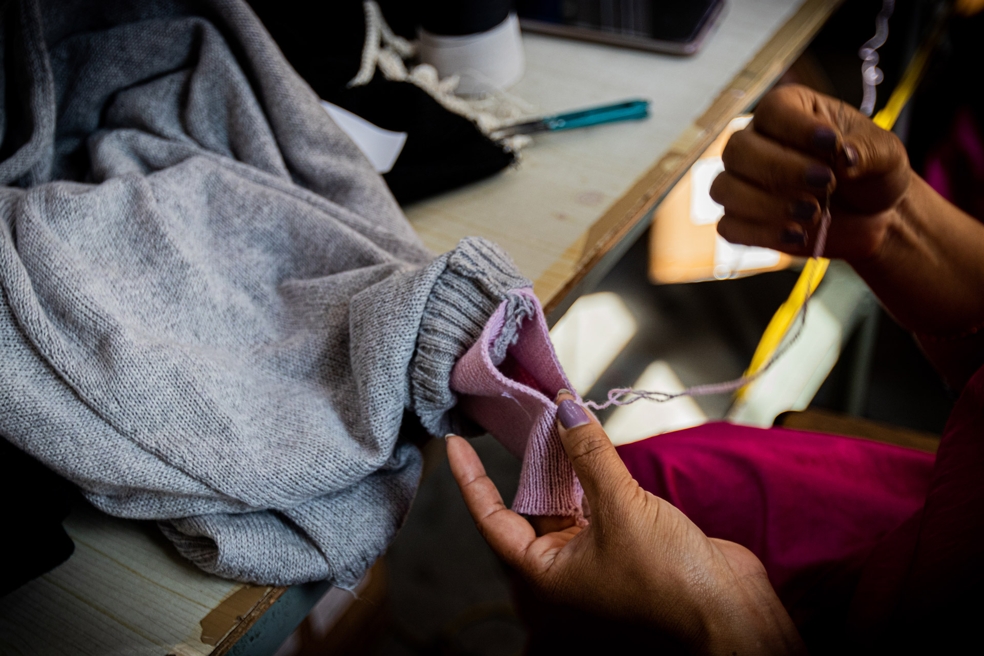 Hand mending and inspection of a cashmere piece at Pashmina Studio