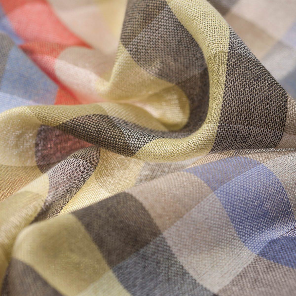 Close-up of check-woven cashmere fabric in camel, cream and charcoal