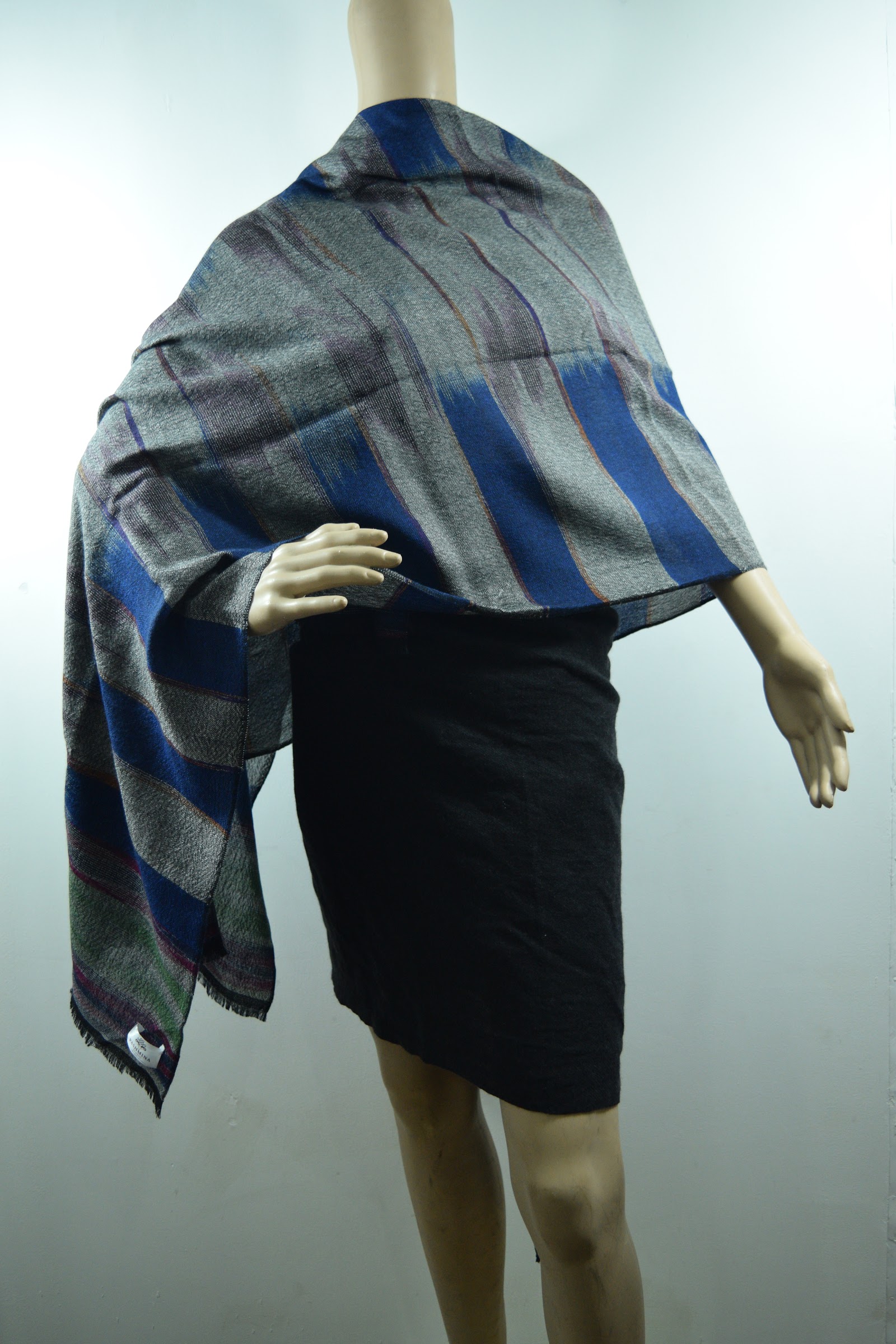 Grey woven cashmere wrap with blue stripes on a mannequin