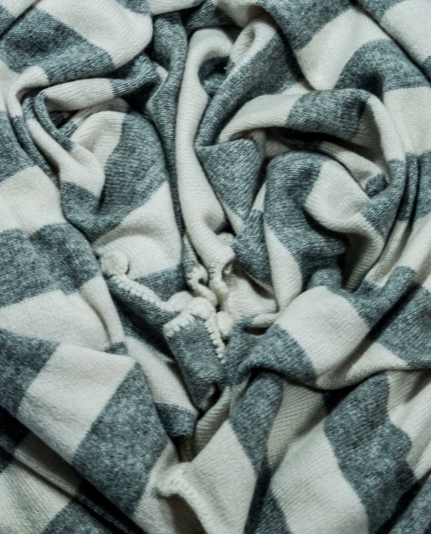 Close-up of grey and ivory striped knitted cashmere fabric